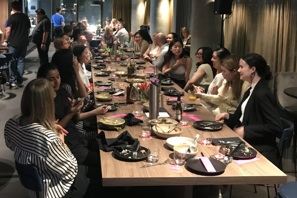 People dining in a long table at a restaurant